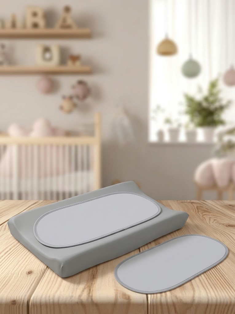 Baby changing pad with removable cover in a soft nursery setting