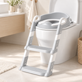 Grey and white potty-training seat with two steps and side handles; toilet and bathroom accessories not included