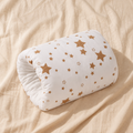 White nursing arm pillow with tan star print on warm beige linen
